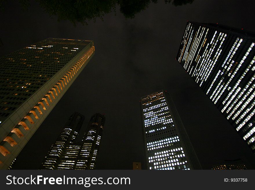 Skyscrapers in Tokyo at night from below