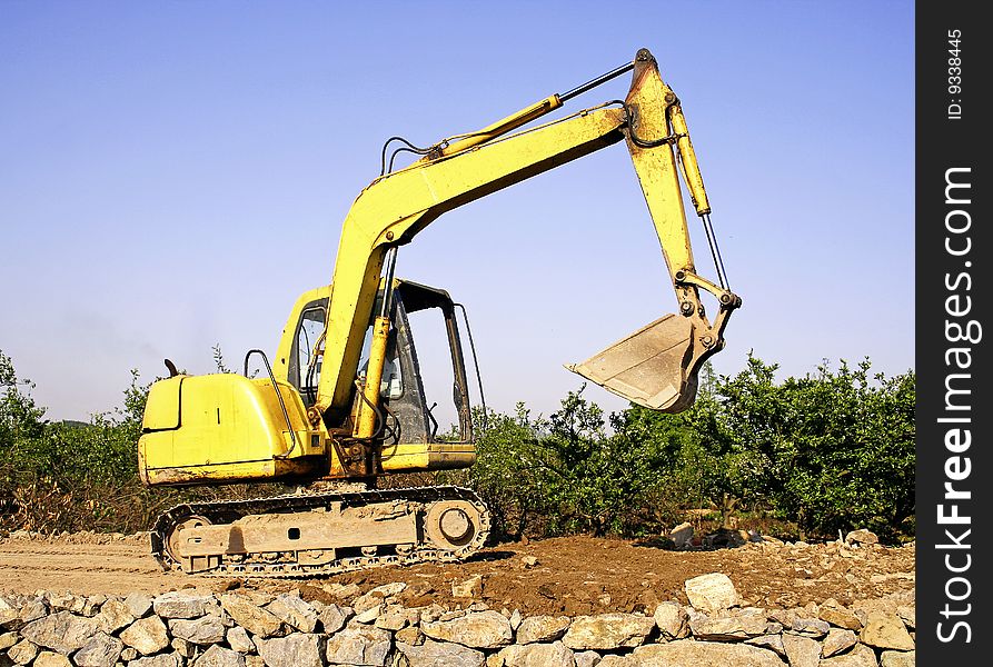 Orange excavator at construction site.