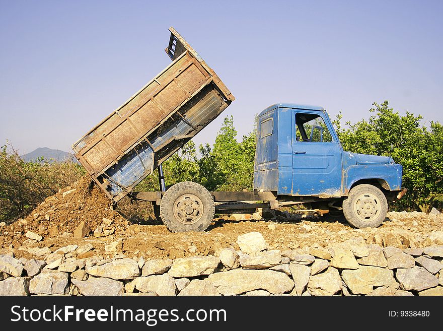 Tractor transport stone on the stone Road