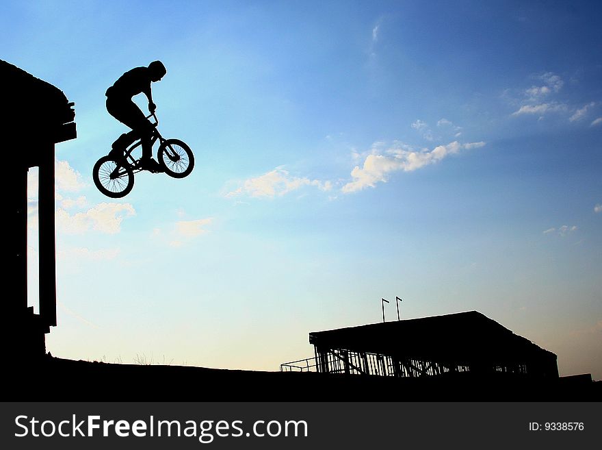 Extreme-athlete commits a dangerous stunt and jump off a bicycle with a large height. Extreme-athlete commits a dangerous stunt and jump off a bicycle with a large height