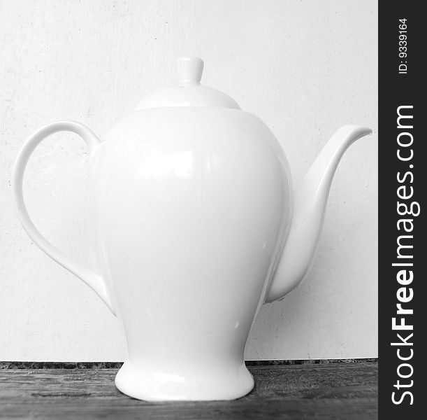 Big white teapot against the white background