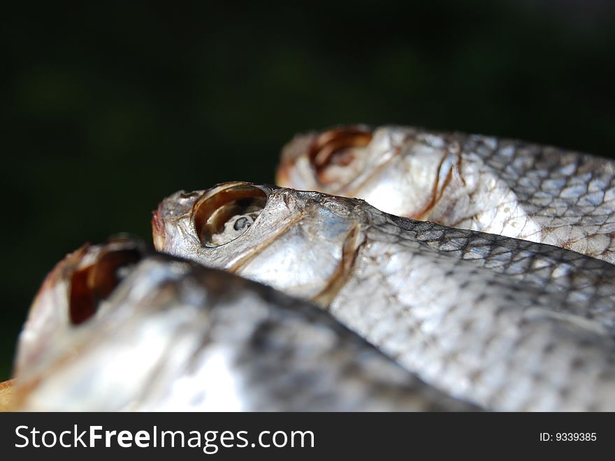 Close-up dried fishes against the black background. Close-up dried fishes against the black background