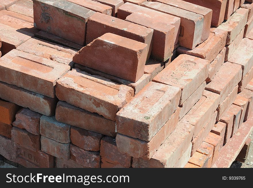 An image of a skid of red bricks.