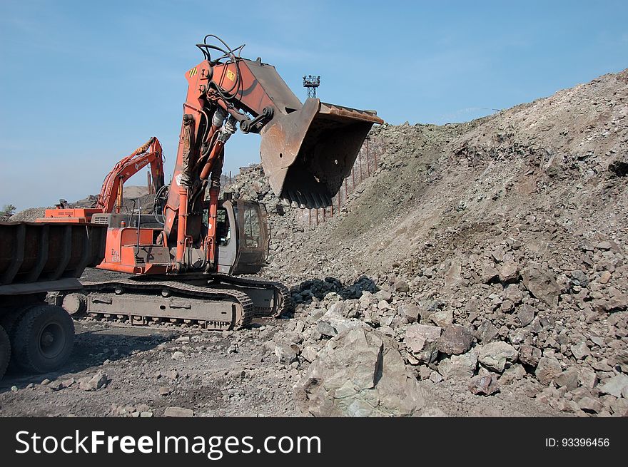 Excavator grab stones with bucket. Excavator grab stones with bucket