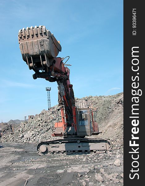 Excavator grab stones with bucket. Excavator grab stones with bucket