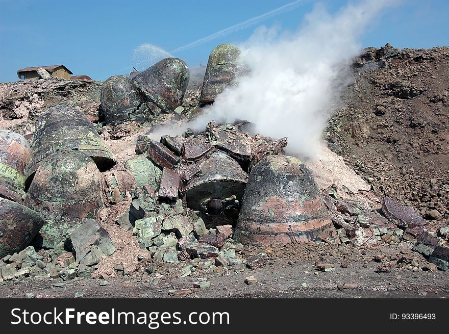 Stones of byproduct plant waste with vapour in industrial quarry. Stones of byproduct plant waste with vapour in industrial quarry