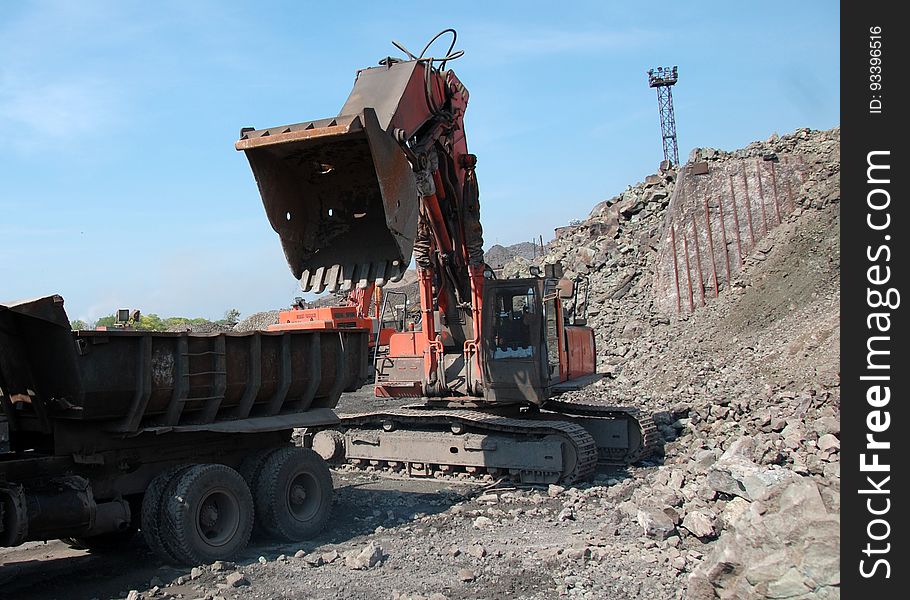 Industrial equipment excavator in quarry load stones. Industrial equipment excavator in quarry load stones