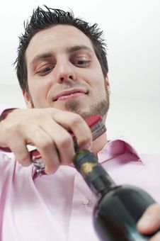 Young Man Opening A Bottle Of Red Wine Royalty Free Stock Photos Young Man Opening A Bottle Of Red Wine Royalty Free Stock Photos