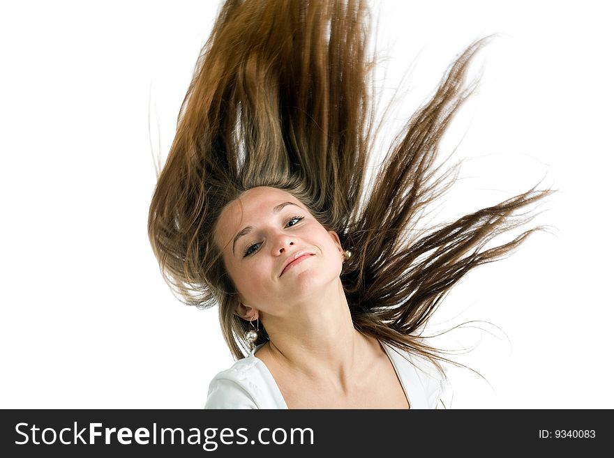 Fashion portrait of a young woman with hair lightly fluttering in the wind  on a white background. Fashion portrait of a young woman with hair lightly fluttering in the wind  on a white background