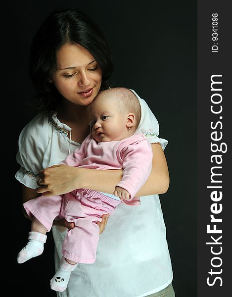 Mom and little baby girl over white background