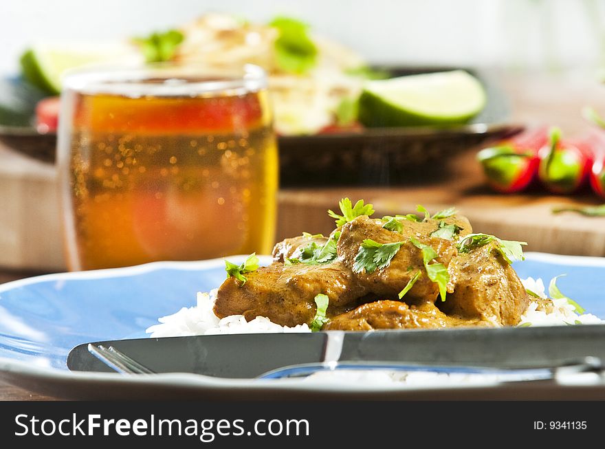 Chicken curry served  with rice and garnished with cilantro leaves