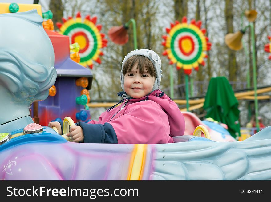 Portrait of little girl at the roundabout. Portrait of little girl at the roundabout