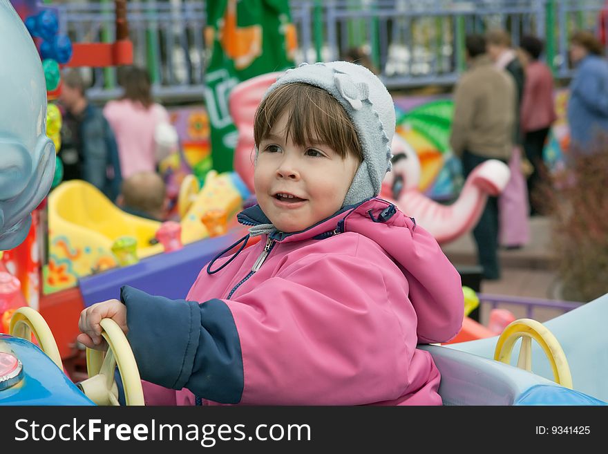 Portrait of little girl at the roundabout. Portrait of little girl at the roundabout