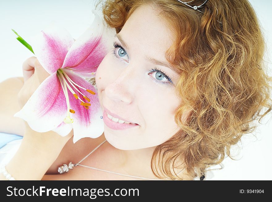 Portrait of a smiling young woman with lily flower. Portrait of a smiling young woman with lily flower