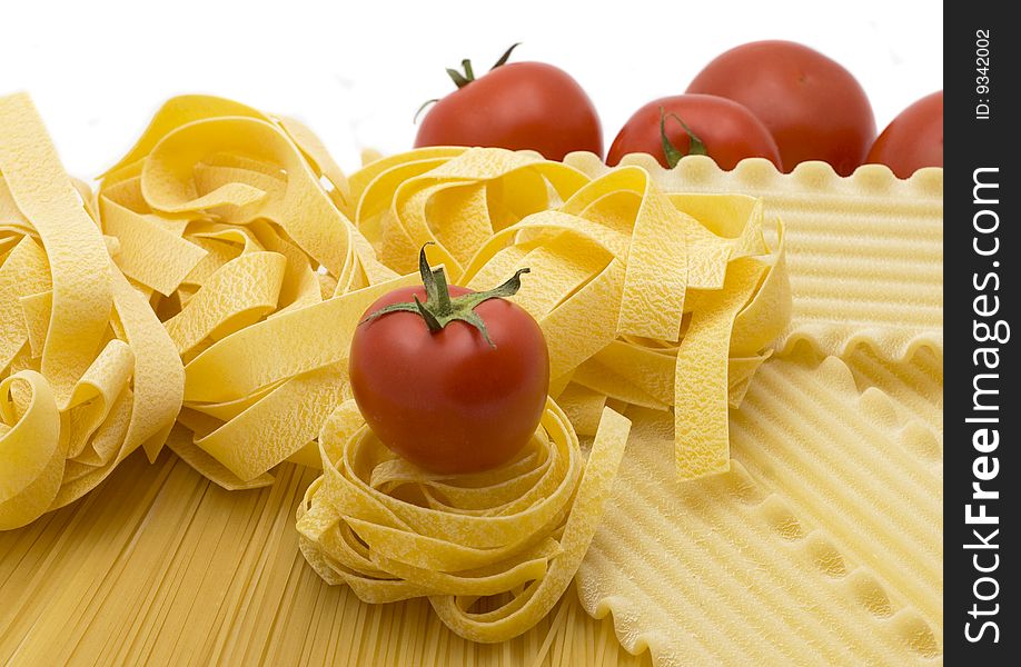 Spaghetti and mature tomatos isolated on a white background. Spaghetti and mature tomatos isolated on a white background