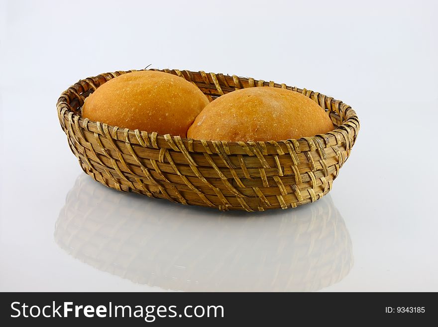 Fresh baked rolls in a basket on white. Fresh baked rolls in a basket on white