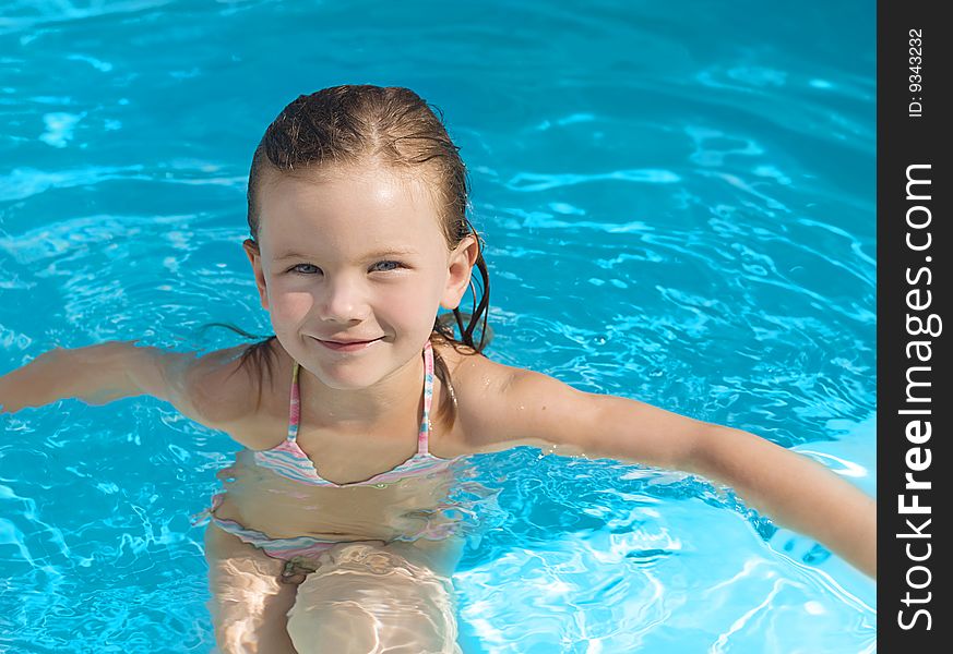 Girl in the swimming pool smiling