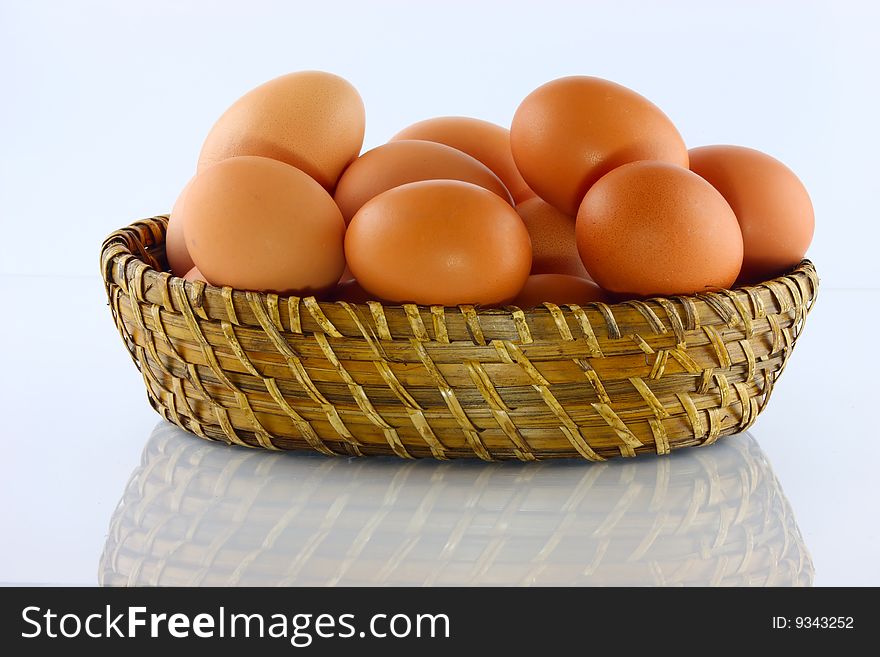 Eggs in wicker basket with white background