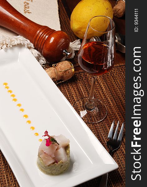 Raw fish on plate decorated with glass of wine. Raw fish on plate decorated with glass of wine