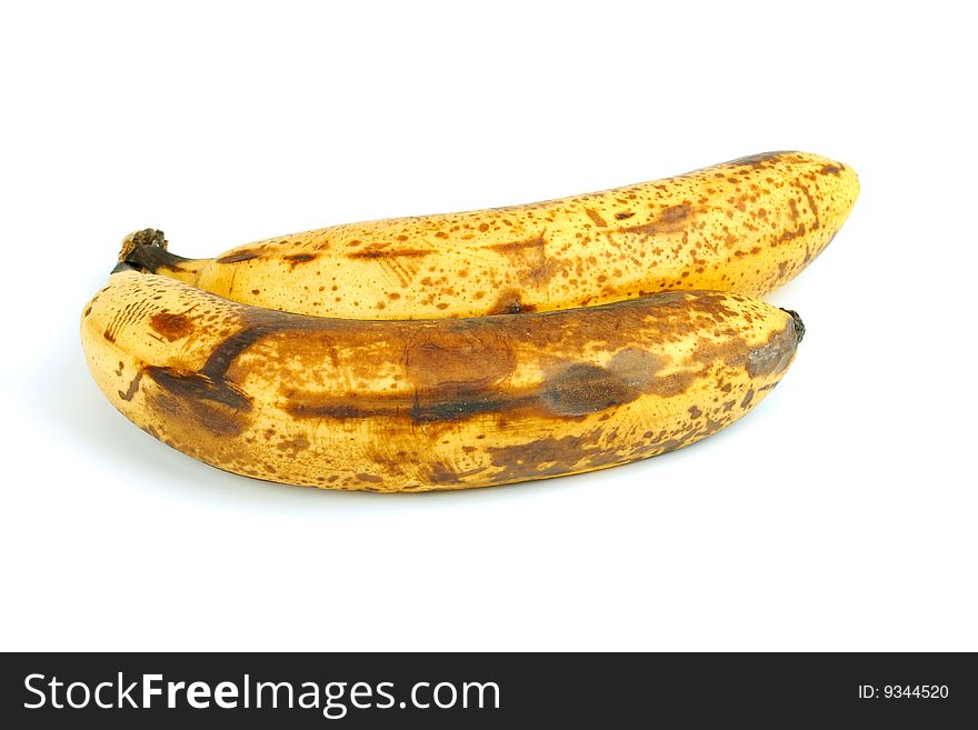 Two old bananas next to each other on a white background