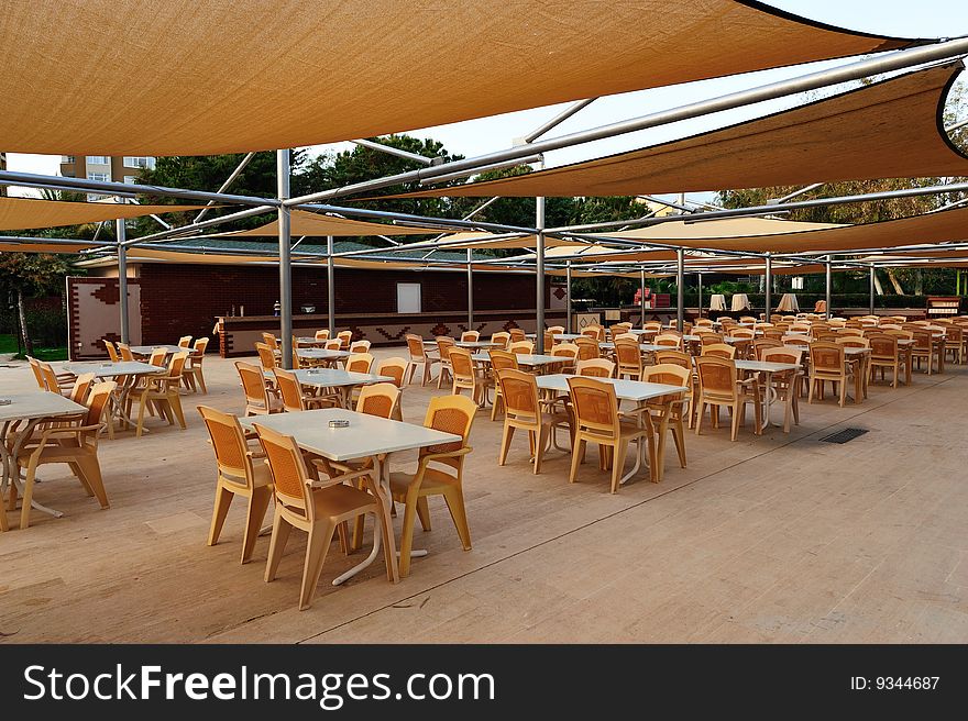 Tables and chair under shed of cafe