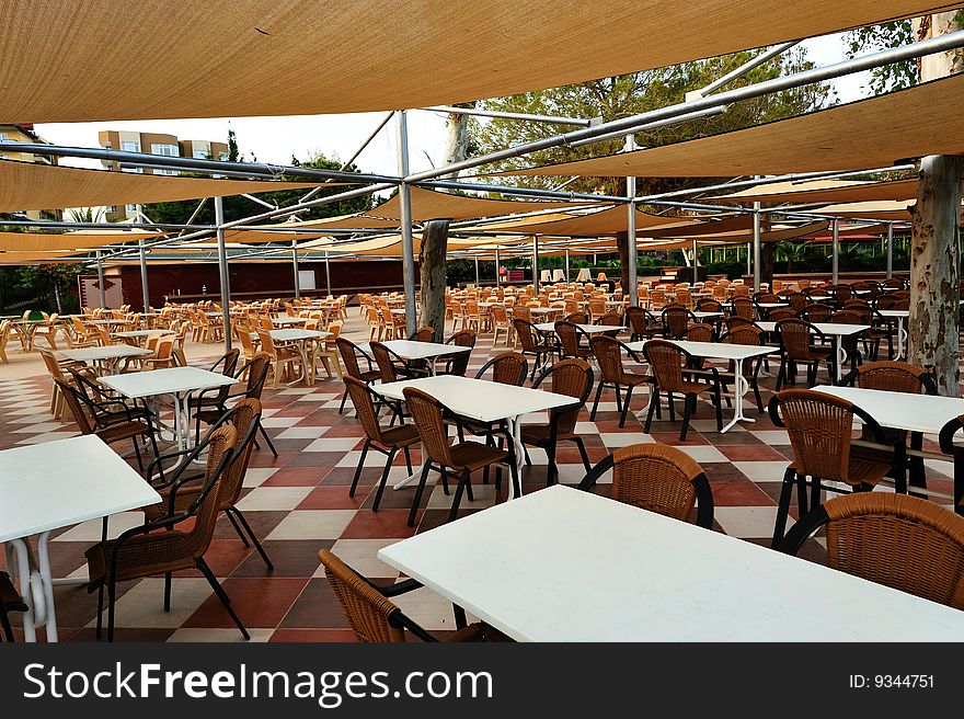 Tables and chair under shed of cafe