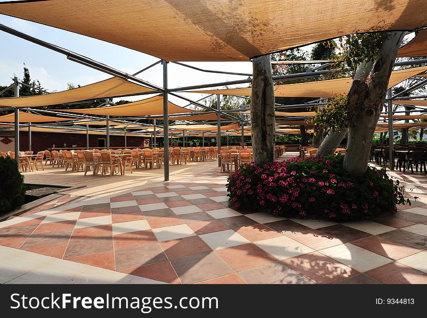 Tables and chair under shed of cafe