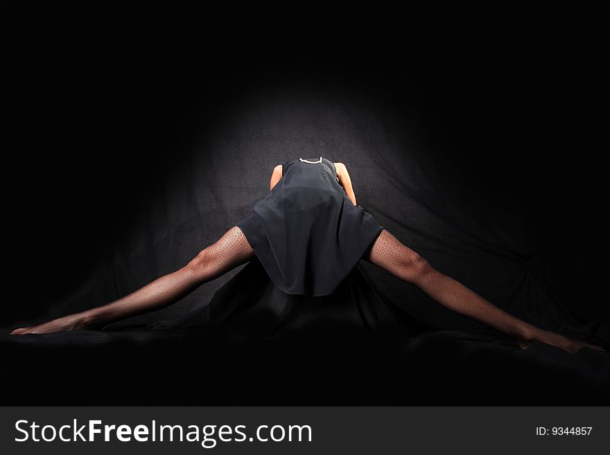 Girl with long legsl against black background