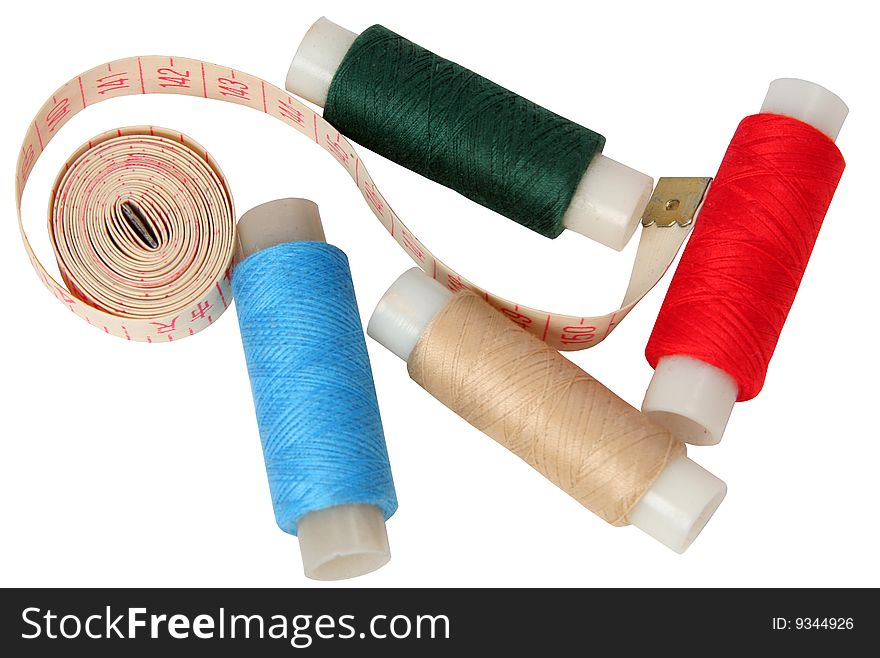 Set of coils of threads with a measured tape on a white background