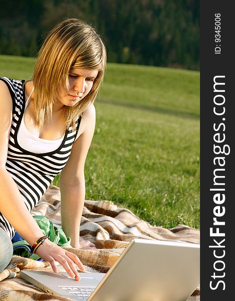 Portrait of beautyful woman in summer outdoors working on laptop computer. Portrait of beautyful woman in summer outdoors working on laptop computer