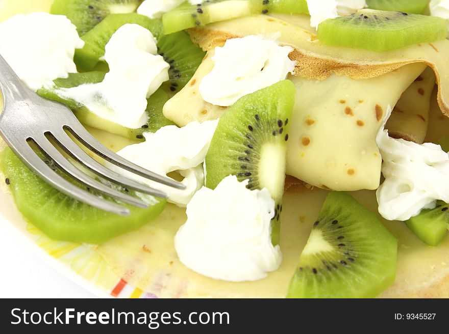 Delicious pancakes with kiwi and cream