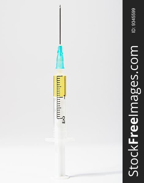 Medical syringe with a needle on a light background. Medical syringe with a needle on a light background