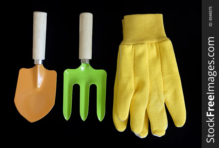 Colorful garden tools isolated on black background