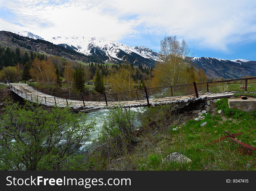 The old bridge through the mountain river