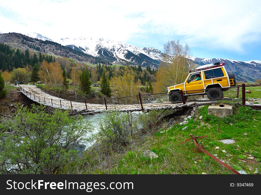 The old bridge through the mountain river