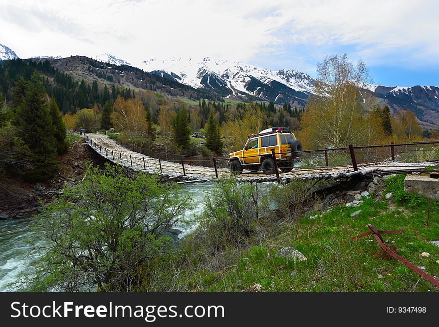 The old bridge through the mountain river