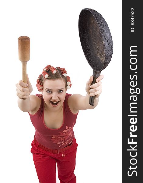 Housewife with curlers in her hair, holding a frying pan. Woman in hair rollers with an angry expression. Angry girl in hair rollers. Isolated over white background. Housewife with curlers in her hair, holding a frying pan. Woman in hair rollers with an angry expression. Angry girl in hair rollers. Isolated over white background.