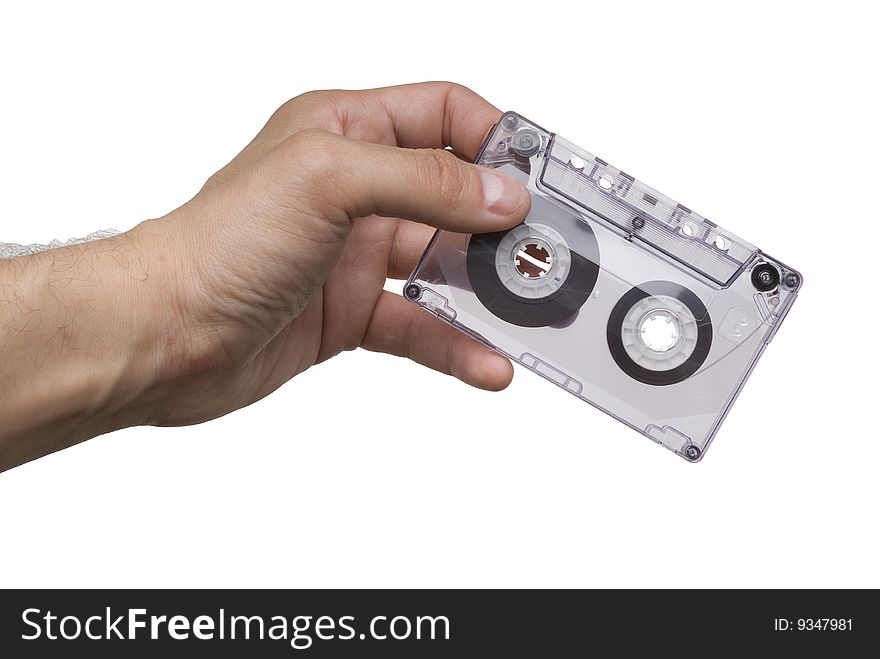 Man hand with an old audio cassette isolated on white background