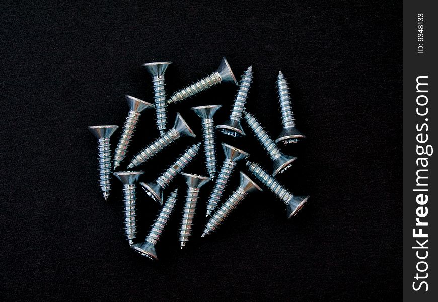 Close up of countersunk chrome wood screws. Close up of countersunk chrome wood screws