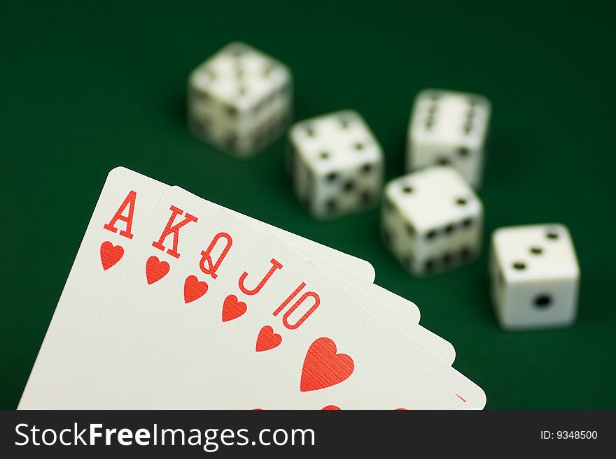 Royal flush hearts and dices on green background. Royal flush hearts and dices on green background