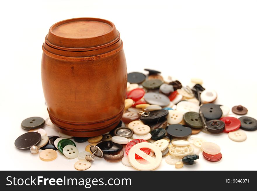 Wooden keg on a  background from various buttons