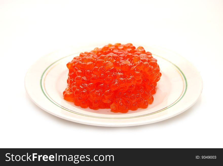 Red caviar on plate isolated white
