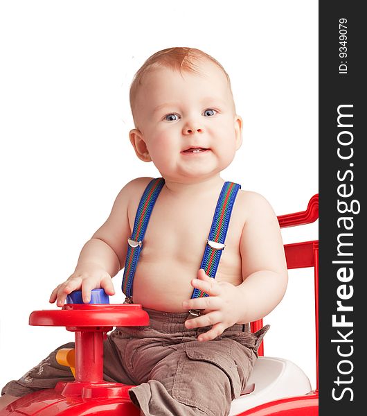 Small boy sitting with a toy on white background. Small boy sitting with a toy on white background