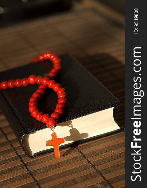 Book and red beads with cross. Book and red beads with cross