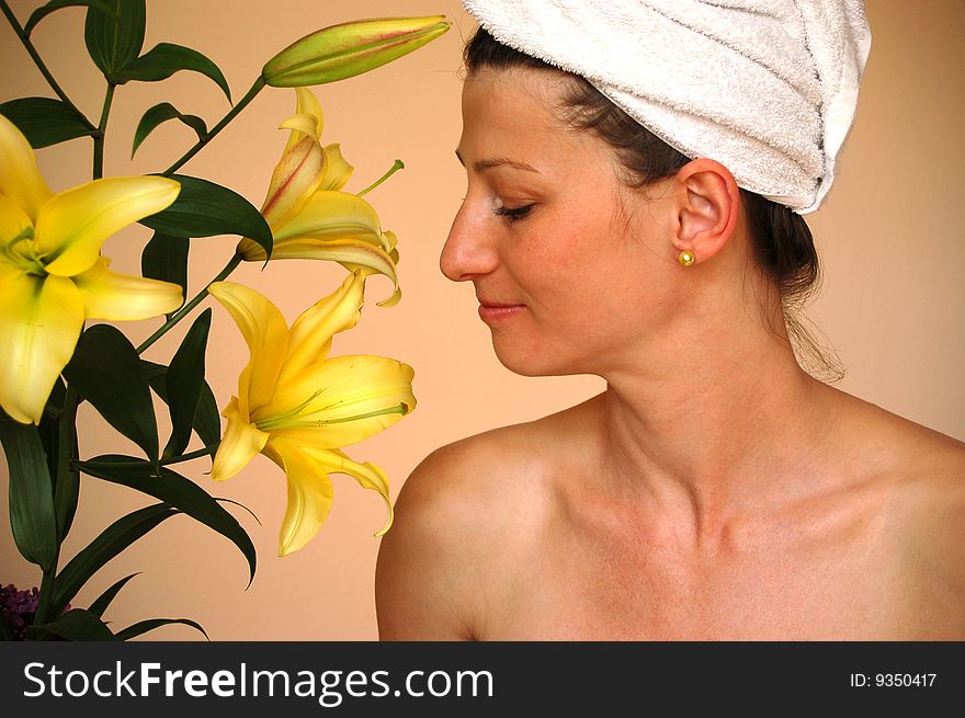 Beautiful woman looking at yellow lilies. Beautiful woman looking at yellow lilies