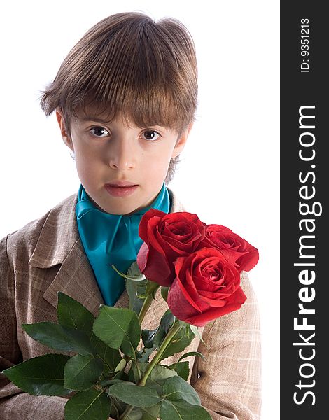 The portrait of the boy with a bouquet from three roses looks in the chamber the isolated white background