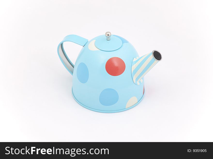 Child's toy teapot against a white background
