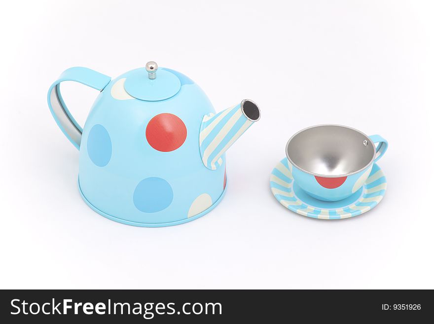 Child's toy teapot and cup against a white background