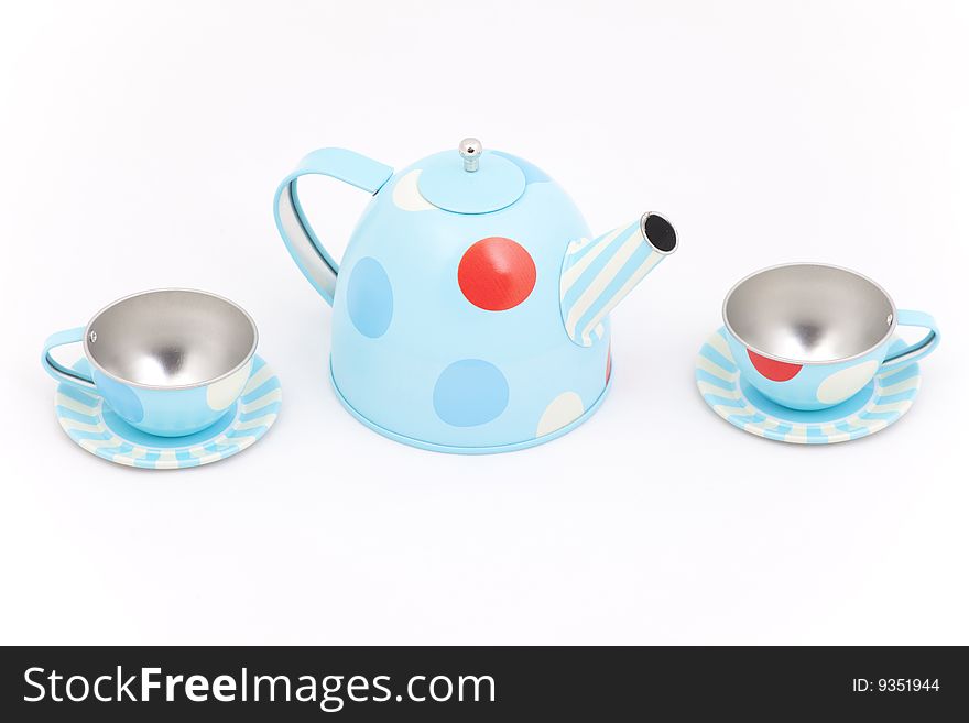 Teapot and teacups against a white background
