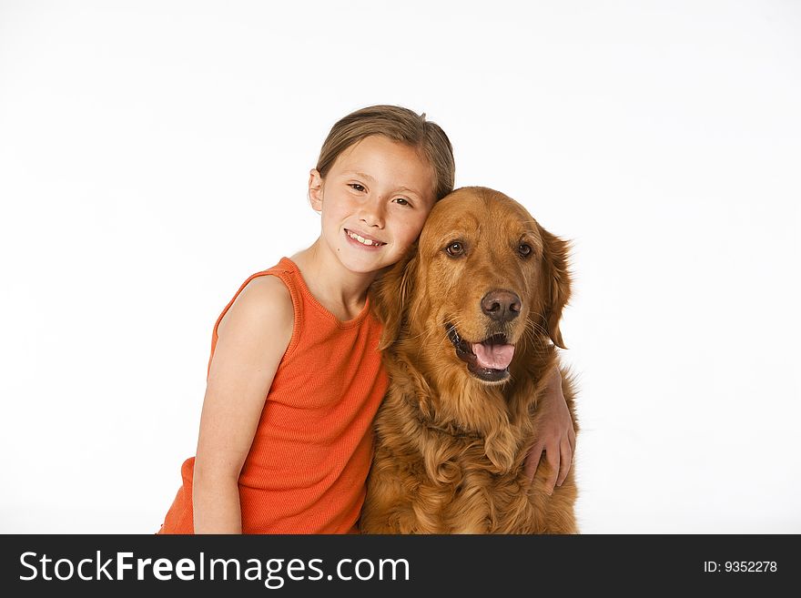 Young girl with golden retriever on white.